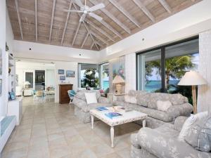 a living room with a couch and a table at HoHum - Private Beachfront House on Exclusive Windermere home in Savannah Sound
