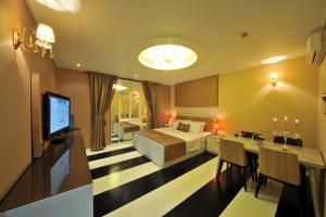a hotel room with a bed and a television at S Hotel in Gwangju