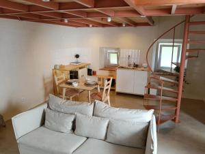 a living room with a white couch and a table at Porta 4 Azeitão, holiday house in Azeitao