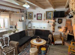 a living room with a couch and a table at Bujtina Boci in Librazhd