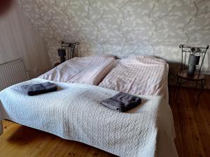 two beds in a bedroom with towels on them at Torp Källtorp B&B in Kisa +6 photos