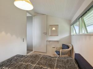 a bedroom with a bed and a window at Lovely Summerhouse By Skaastrup Strand W Sea View in Bogense