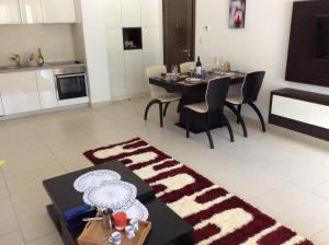 a kitchen and living room with a table and chairs at Lavender Bay Apartment Dee B02 in Donji Morinj