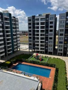 an overhead view of two apartment buildings with a pool at Homely Haven Two Bedroom Near JKIA in Nairobi +9 photos