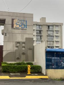 a yellow fire hydrant in front of a building at 2 BR Condo near San Jose, Costa Rica in Santa Cruz