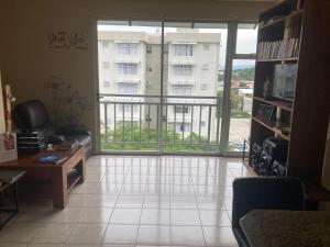 a living room with a view of a building at 2 BR Condo near San Jose, Costa Rica in Santa Cruz +4 photos