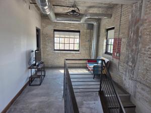 a room with a staircase and a brick wall at The Mill Hotel in Fergus Falls +22 photos