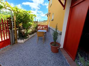 a patio with a table and a chair on a building at Um quarto da Casa do Monte Adega in Água de Alto