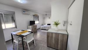a room with a table and a bedroom with a bed at MCa394BIS in Paraná