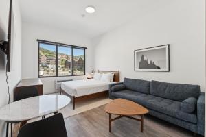 a living room with a couch and a bed at Pioche Village Park City in Park City +25 photos