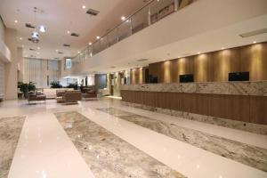 a lobby of a hotel with a reception desk at Samba Hotel Linhares in Linhares