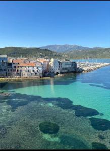 a group of buildings on the shore of a body of water at Appartement plein centre Saint Florent face au port in Saint-Florent