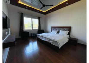 a bedroom with a bed and a television in it at Dreamland Resort in Nainital