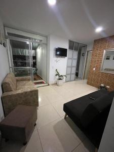 a living room with a couch and a table at apartamento cerca al mar in Estación El Salto