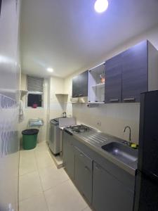 a kitchen with a sink and a counter top at apartamento cerca al mar in Estación El Salto