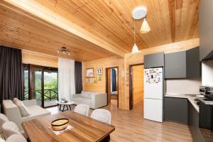 a kitchen and living room with a wooden ceiling at Likani Verde in Borjomi +40 photos