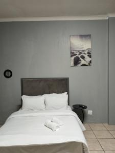 a bedroom with a bed with a towel on it at Entire rental unit in Pretoria