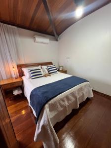 Postel nebo postele na pokoji v ubytování Chácara Vista para o Mar Piúma Próximo a Iriri até 23 pessoas com camping