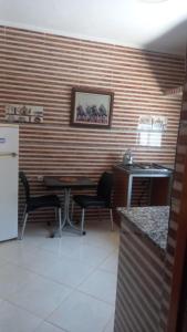 a kitchen with a table and chairs in a room at khadija oulidia in Oualidia