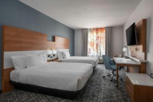a hotel room with two beds and a desk at Fairfield Inn & Suites Oakland Hayward in Hayward +23 photos