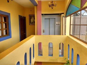 a hallway with a house painted on the wall at Hotel La Casona del Vizconde in Guanajuato