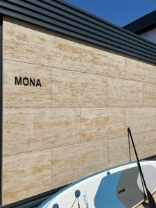 a sign on the side of a building at Mobile House Mona in Drage