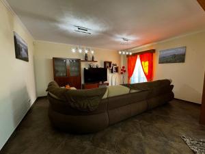 a living room with a large couch in a room at Casa MiraMar in Rabo de Peixe