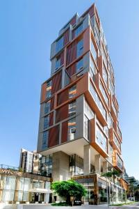 a tall building with many windows on a street at The Westin Sao Paulo in Sao Paulo