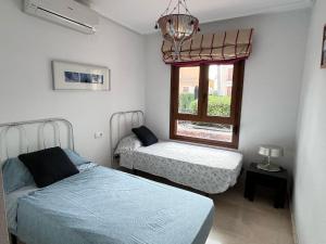 a bedroom with two beds and a window at Las colinas golf in Ciudad Quesada
