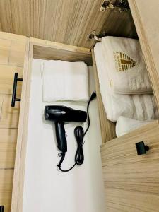 a black hairdryer sitting on a shelf in a room at El Rincón de Monte Alban in Oaxaca City