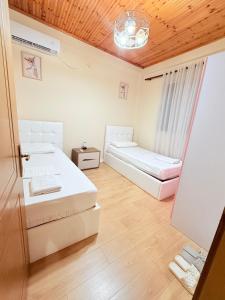 a bedroom with two beds and a window at La Piscina in Shkodër +28 photos