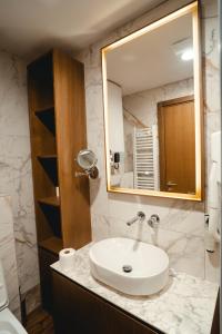 a bathroom with a sink and a mirror at Zlatibor Lux Spa Apartments in Zlatibor +23 photos
