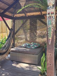 a bed in a hammock on a deck at Chale lá bella villa in Palhoça