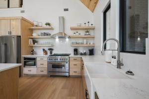 a kitchen with white counters and a stove top oven at A-Frame of Mind - Modern Farmhouse in Stephens Gap