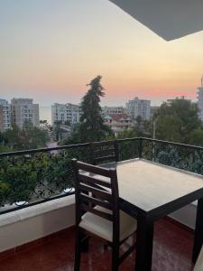 a table and chair on a balcony with a view at Villa Sofia in Durrës