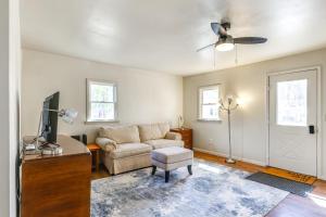 a living room with a couch and a tv at 1 Mi to Dtwn Saratoga Springs Cozy Duplex Apt! in Saratoga Springs