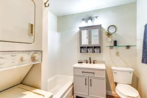a bathroom with a toilet and a sink and a mirror at 1 Mi to Dtwn Saratoga Springs Cozy Duplex Apt! in Saratoga Springs +16 photos