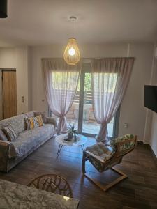 a living room with a couch and a table at Cute Corner in Khalkoútsion