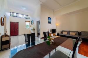 a living room with a glass table and a couch at Dhome by Riana in Wendit