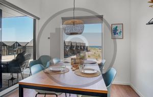 a dining room with a table and chairs and a large window at Havnehusene, Lejl 36 in Slagelse
