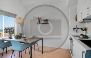 a kitchen and dining room with a table and chairs at Havnehusene, Lejl 36 in Slagelse