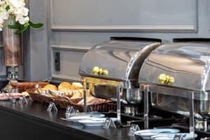 a buffet line with bread and baskets of food at Hayer Hotel in Erechim