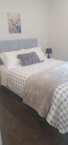 a bedroom with two beds and a picture on the wall at Arbor Suite in Greytown +23 photos