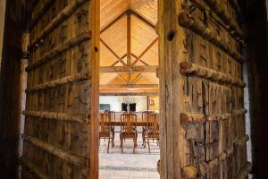 an open door to a dining room with a table at Peppers Creek Accommodation in Pokolbin