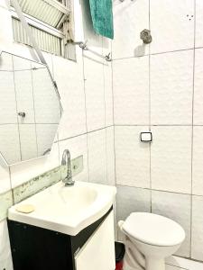 a bathroom with a sink and a toilet at Mar à porta in São Vicente +4 photos