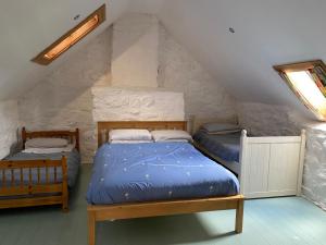 a bedroom with two beds in a attic at The Cottage @ Mill Haven place in Pembrokeshire