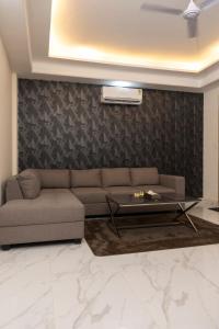 a living room with a couch and a table at Nomad 2BHK by Luxury Heights in Rishīkesh