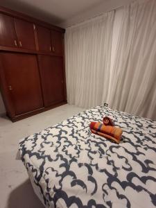 a bedroom with a bed with a stuffed animal on it at 1 room apartment Delta in Sharm El Sheikh +6 photos