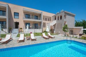 a villa with a swimming pool in front of a building at Luxury Sirens Fresh in Limenas