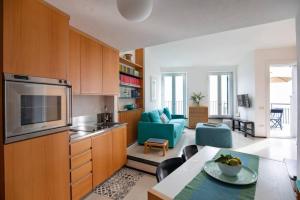 a kitchen and living room with a couch and a table at Il Ciasso Romantic Seafront Escape in Vernazza